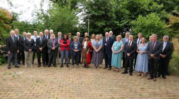 A photograph of all 31 members of West Devon Borough Council, taken outside the offices at Kilworthy Park. In the centre of the group, The Mayor Cllr Lynn Daniel wears her full regalia.