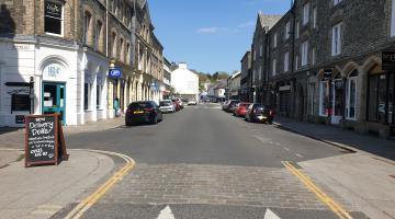 A photo of the main street in Tavistock, with cars parked either side of the street.