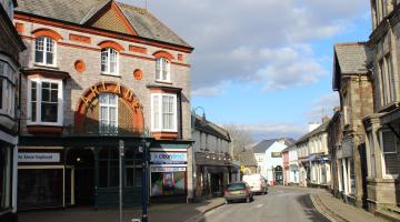 A street in Okehampton, with the entrance to the Victorian gothic arcade on the left.