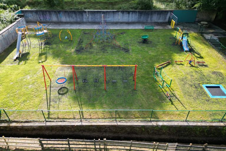 An aerial photograph of the Bannawell Street Play Park, showing off the new equipment, including slides, swings, a balancing beam and in-ground trampoline.