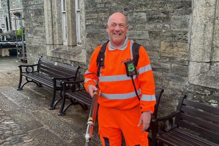 A waste worker in high vis clothing with the new chewing gum cleaning equipment.