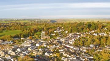 aerial view of a town in rural setting with church and houses
