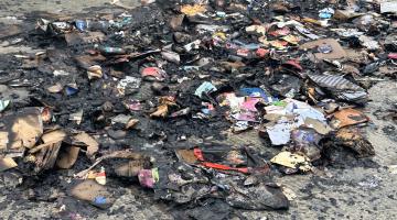 The remnants of recycling set on fire by a battery placed incorrectly in a recycling container.