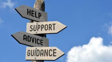 signpost which reads help, support, advice, guidance